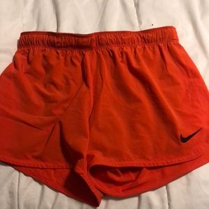 Orange Nike shorts. Size small